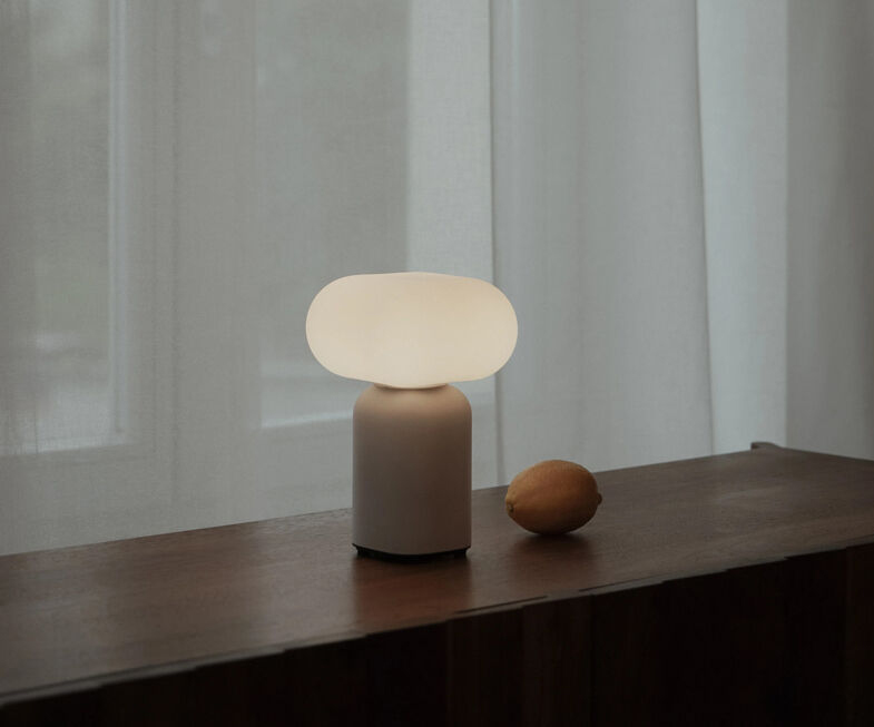 Velis Table Lamp - Lightweight Design, Compact and Wireless, Easy to Carry Anywhere 1 “Velis table lamp with rounded cloud‑like shade and cylindrical base on a concrete windowsill beside an open book